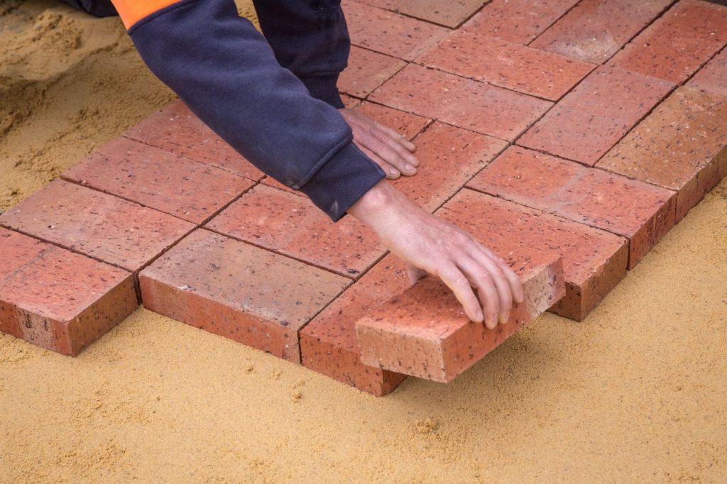 pexels photo 4509089 From above crop unrecognizable construction worker in uniform laying bricks on ground in daylight